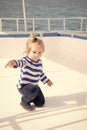 Little baby captain on boat on summer cruise, nautical fashion Royalty Free Stock Photo