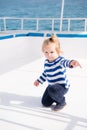 Little baby captain on boat on summer cruise, nautical fashion