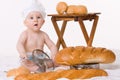 Little baby chef with bread over white