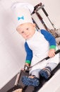 Little baby chef in the cook hat with metal ladle Royalty Free Stock Photo