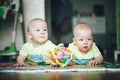Infant Baby Child Twins Brothers Six Months Old is Playing on the Floor Royalty Free Stock Photo