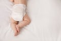Little baby in diaper on bed, top view. Space for text Royalty Free Stock Photo