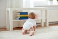 Little baby in diaper crawling on floor at home Royalty Free Stock Photo