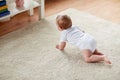 Little baby in diaper crawling on floor at home Royalty Free Stock Photo