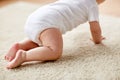 Little baby in diaper crawling on floor at home Royalty Free Stock Photo