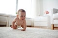 Little baby in diaper crawling on floor at home Royalty Free Stock Photo