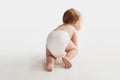 Little baby in diaper crawling on white floor Royalty Free Stock Photo