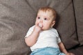 Little baby with a dummy is crying while sitting on the bed. Disputes and quarrels mothers with a small child Royalty Free Stock Photo