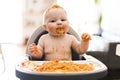 Little baby girl eating her spaghetti dinner and making a mess Royalty Free Stock Photo