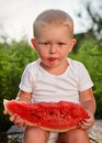 Little baby eating watermelon outdoors