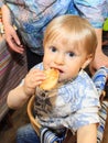 Little baby eats tasty bread.