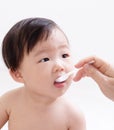 Little baby feeding with a spoon