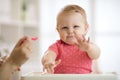 Little baby feeding with a spoon Royalty Free Stock Photo