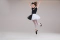 Little baby girl ballerina dancing in black and white clothing smiling having positive emotion
