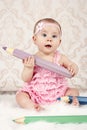 Little baby girl with big crayons Royalty Free Stock Photo