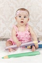Little baby girl with big crayons Royalty Free Stock Photo