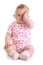 Little baby girl covers her eye with left hand iso
