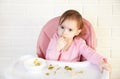 Little baby girl eating her dinner and making a mess Royalty Free Stock Photo