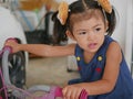 Little baby girl enjoys riding the first bicycle, with training wheels, in her life Royalty Free Stock Photo