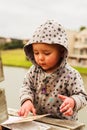 A little baby girl examines a book