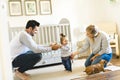 Little baby girl first steps with the help of parent