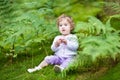 Little baby girl gathering wild raspberries in park Royalty Free Stock Photo