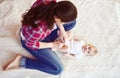 Little baby girl getting dressed by her mother Royalty Free Stock Photo