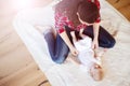 Little baby girl getting dressed by her mother Royalty Free Stock Photo