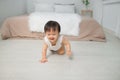 Little baby girl or girl crawling on floor in bed room Royalty Free Stock Photo