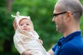 Little baby girl in her father`s arms Royalty Free Stock Photo