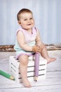 Little baby girl holding big crayon Royalty Free Stock Photo