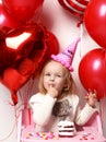 Little baby girl kid celebrate her third birthday with sweet cake on a light party background Royalty Free Stock Photo