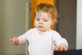 Little baby girl learning walking, standing and making first steps at home. Toddler balancing. Happy child, balance and Royalty Free Stock Photo
