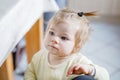 Little baby girl learning walking, standing and making first steps at home. Toddler balancing. Happy child, balance and Royalty Free Stock Photo