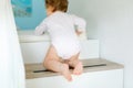 Little baby girl learning walking, standing and making first steps at home. Toddler climbing stairs and balancing. Happy Royalty Free Stock Photo