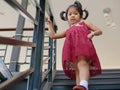 Little baby girl, 42 months old, walking down the stairs by herself, holding on to handrail Royalty Free Stock Photo