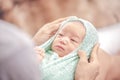 Little baby girl one week in green blanket on mother lap looking at her mother. Baby clothes changing Royalty Free Stock Photo