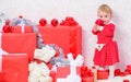 Little baby girl play near pile of gift boxes. Family holiday. Christmas activities for toddlers. Christmas gifts for
