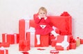 Little baby girl play near pile of gift boxes. Family holiday. Christmas gifts for toddler. Gifts for child first Royalty Free Stock Photo