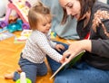 Baby Girl. Joy. Reading. Book. Mother Royalty Free Stock Photo