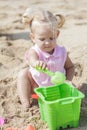 Little baby girl playing sand toys at the beach Royalty Free Stock Photo