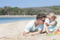 Little baby girl playing sand toys with her father Royalty Free Stock Photo