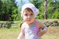 Little baby girl portrait dressing kerchief round her head and swimsuit for swimming, looking at camera Royalty Free Stock Photo