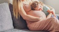 Little baby girl relaxing on mom`s pregnant belly - Pregnant mother with a toddler - Family concept Royalty Free Stock Photo