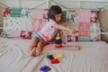 Little baby girl sitting on the bed and playing Royalty Free Stock Photo