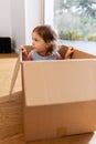 little baby girl sitting in cardboard box at home Royalty Free Stock Photo