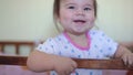 Little baby girl standing on the bed and laughing