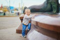 Little baby girl standing close to city fountain on a street of Helsinki, Finland Royalty Free Stock Photo