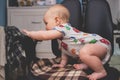 Little baby girl trying to stay in the computer chair Royalty Free Stock Photo