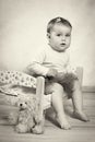 Little baby girl in tutu skirt sitting on the small bed Royalty Free Stock Photo